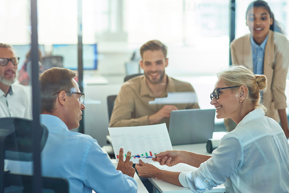 People discussing employee data at a meeting