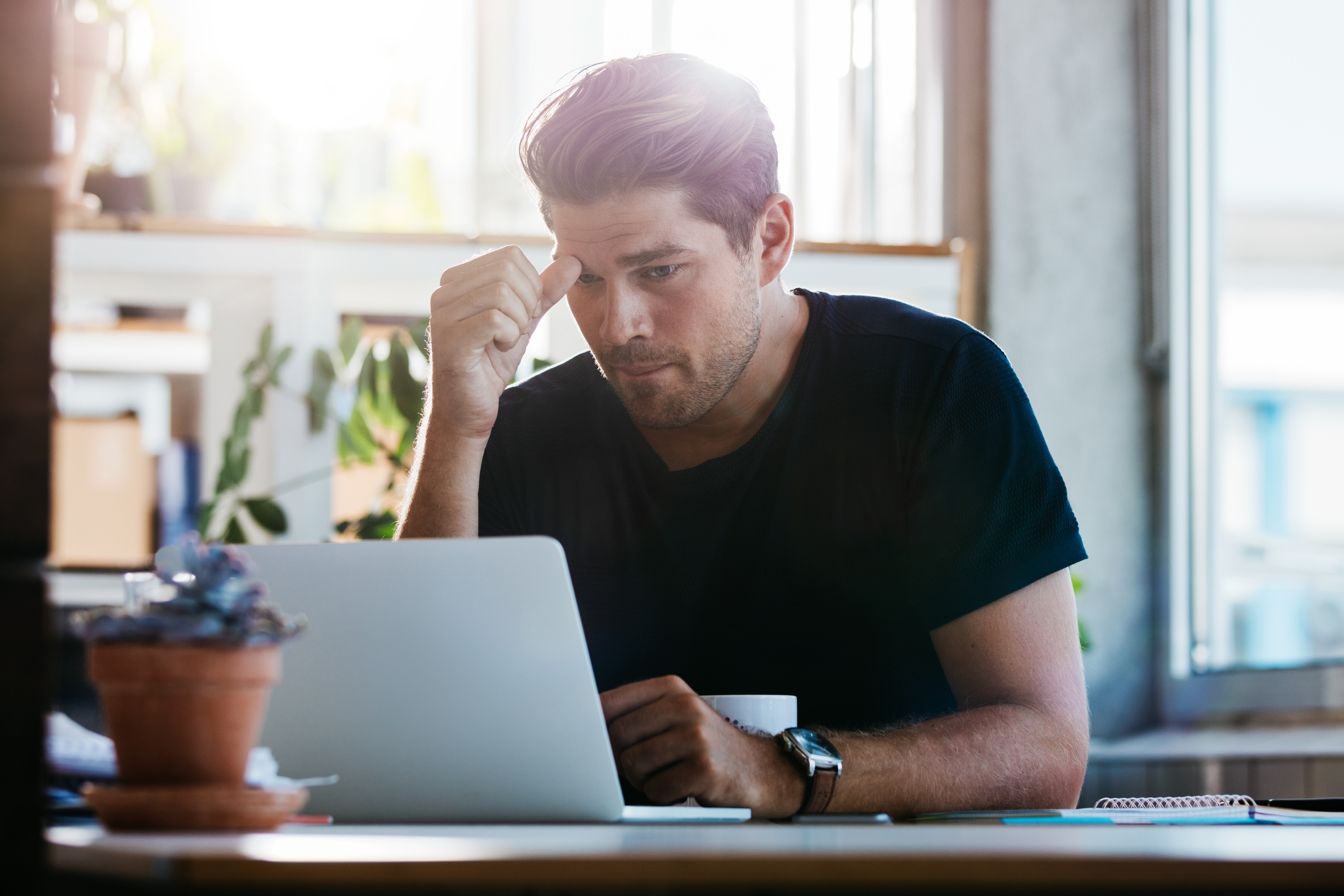 Young man suffering stress at work