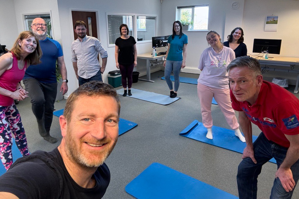 Chris Jones and Posturite colleagues enjoying a Pilates lesson in the office